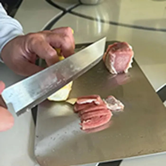 Katori customer John slicing meat on the titanium board