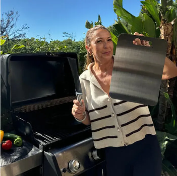 Katori customer Sara holding her titanium board outdoors