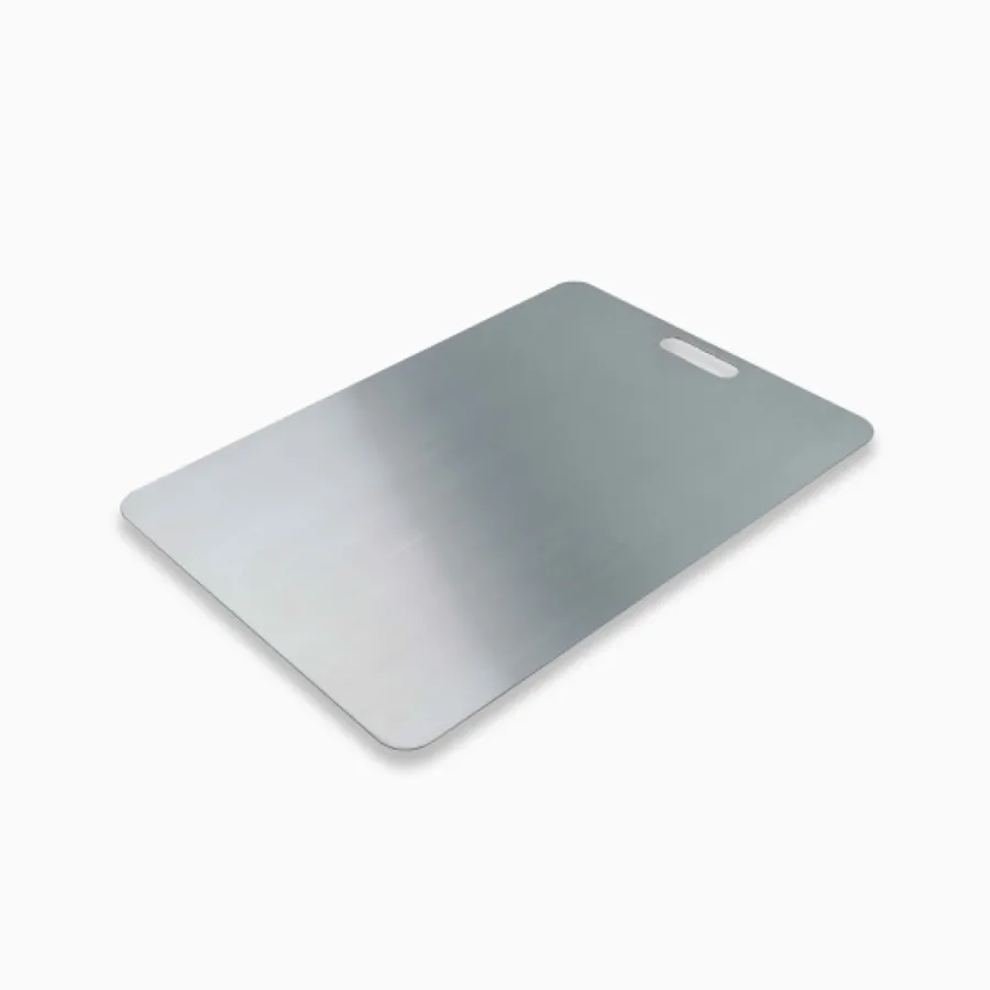 Katori titanium cutting board seen at an angle on a white background