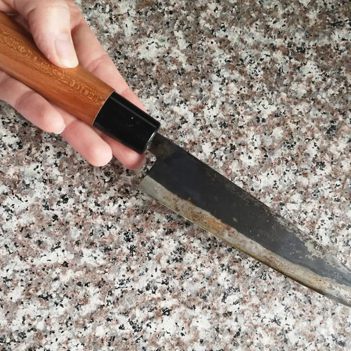 Knife on a hard stone chopping board