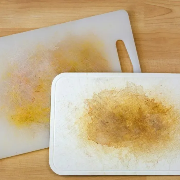 Scratched plastic chopping board with stains