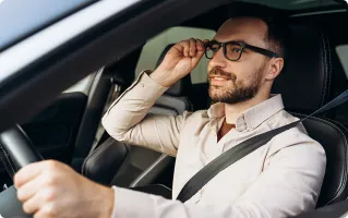 Man driving and taking a hands-free call with smart glasses