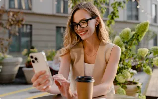 Woman working remotely from a cafe with smart glasses